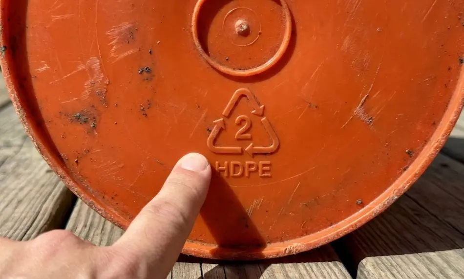 composite visual guide showing three safe plastic types for gardening: an orange 5-gallon bucket labeled with the #2 HDPE triangle